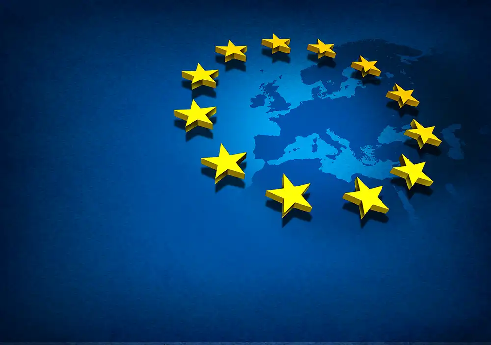 A graphic representation of the European Union flag, featuring a circle of twelve golden stars on a blue background with a faint outline of Europe in the center.